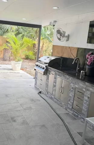 a kitchen with a stove a sink and a microwave