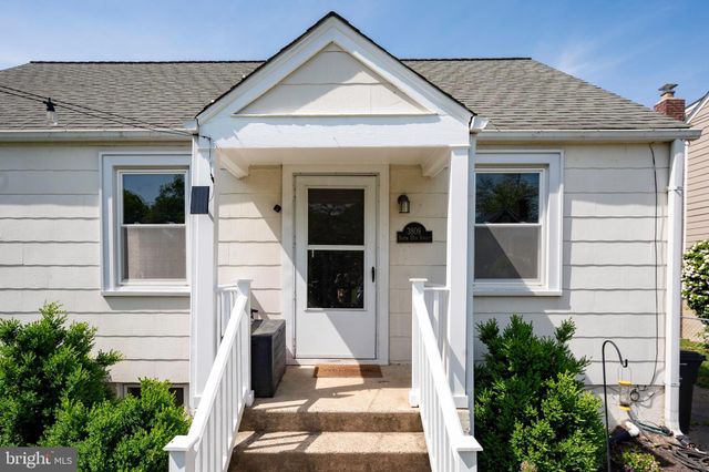 a view of a brick house with potted plants