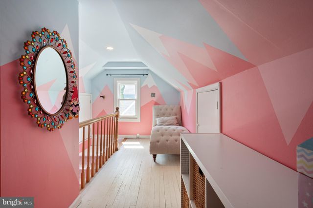 a view of a hallway with entryway wooden floor and front door