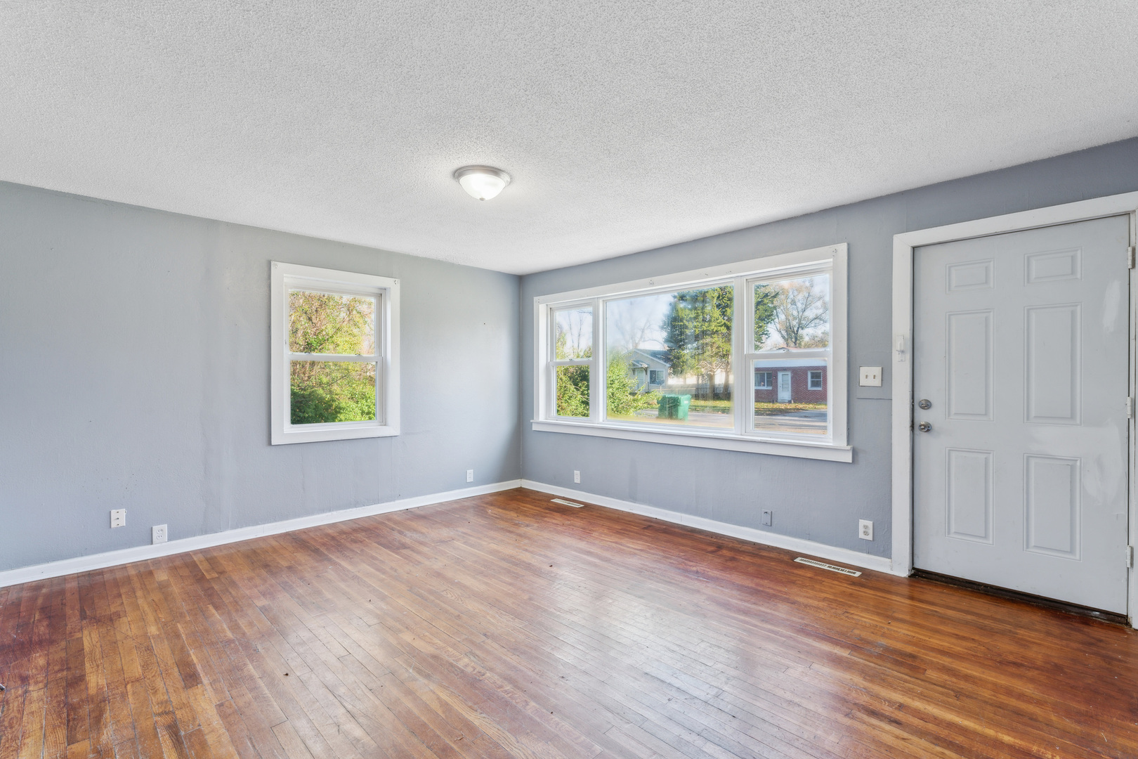 2042 Sandy Ridge Road Cahokia, IL 62206 - Photo 5 of 21 a view of an empty room with wooden floor and a window