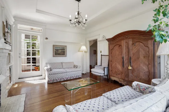 a living room with furniture and a chandelier