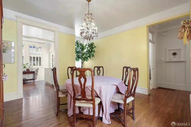 a view of a dining room with furniture wooden floor and chandelier