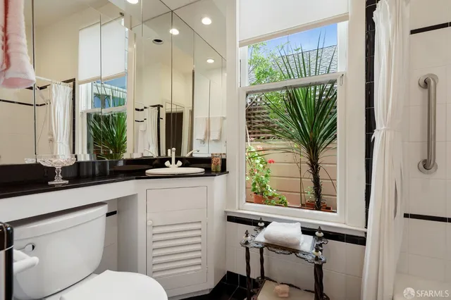 a bathroom with a sink a mirror and a window