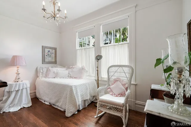 a bedroom with bed and a potted plant