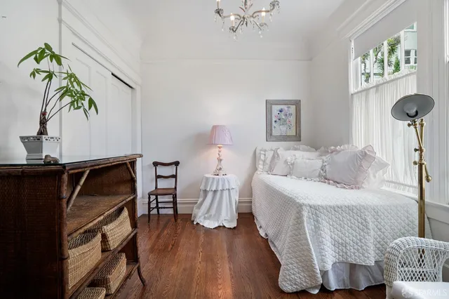 a bedroom with a bed and a chandelier