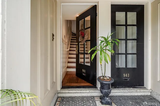 a with a potted plant in front of a door