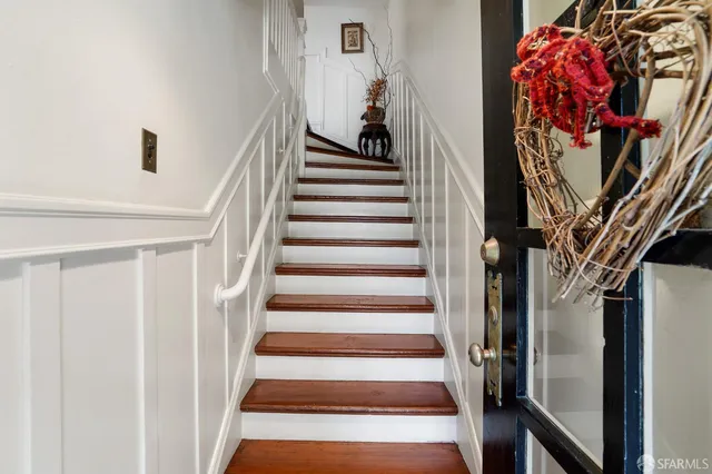 a view of staircase with lots of different colored frames
