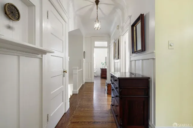 a hallway with a sink and a mirror