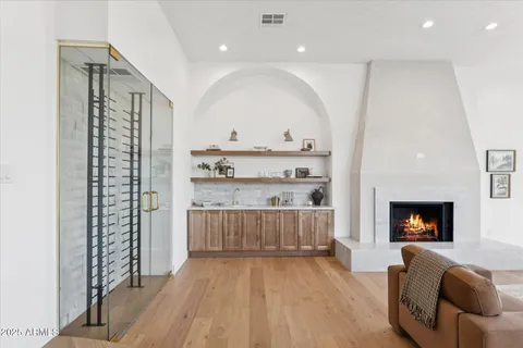 a living room with furniture a large window and a fireplace