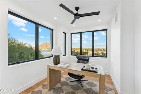a view of empty room with wooden floor and window