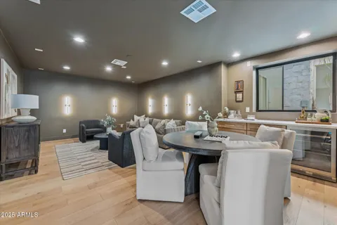 a front view of a house with a yard and potted plants
