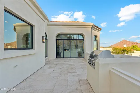a view of a house with a yard and potted plants