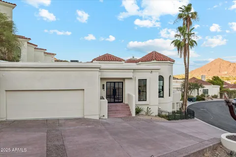 a living room with fireplace furniture and a large window