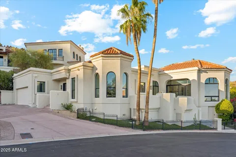 a large building with a mountain in the background