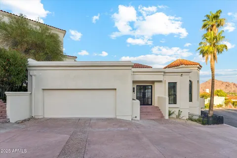 an aerial view of a house with swimming pool and mountain view