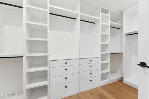 a front view of a building with mountain view and trees