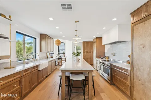 a kitchen with a sink a stove and a microwave