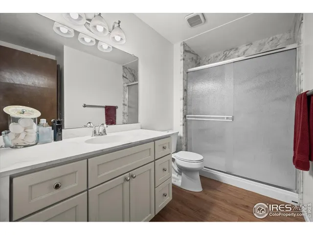 a bathroom with a double vanity sink toilet and shower