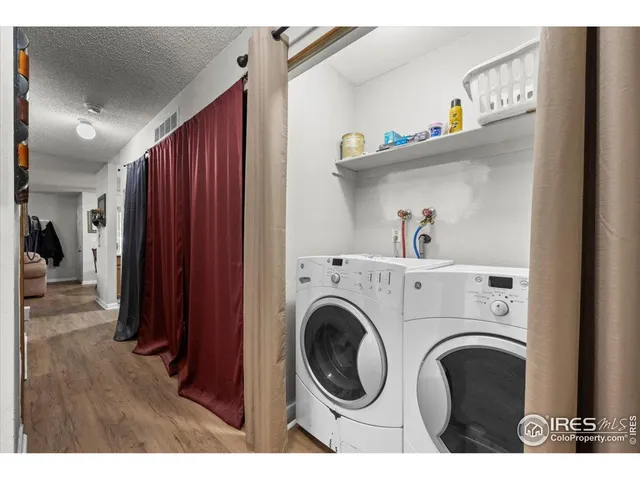 a view of washer and dryer with kitchen in the background