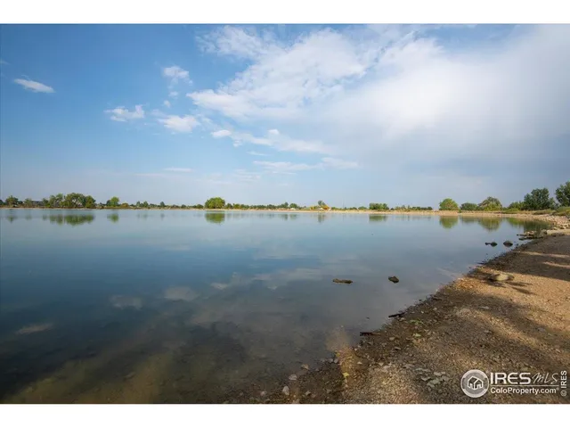 a view of a lake with houses in the back