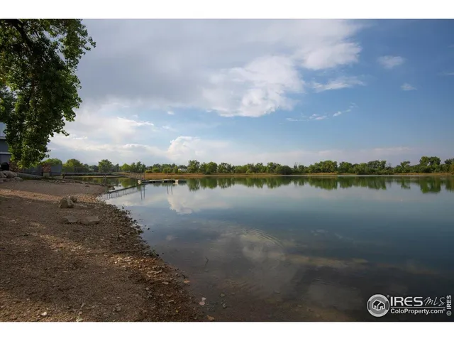 a view of a lake with houses in the background