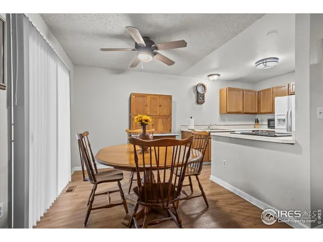 a view of a dining room with furniture and a chandelier