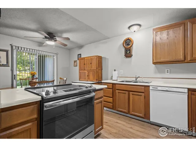 a kitchen with stainless steel appliances granite countertop a sink stove and cabinets