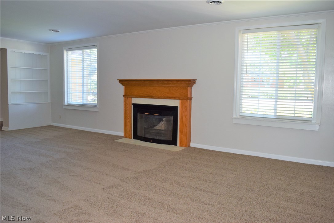 616 Everhard Road Southwest North Canton, OH 44709 - Photo 5 of 18 Large living room that offers a wood burning fireplace and built in shelves.