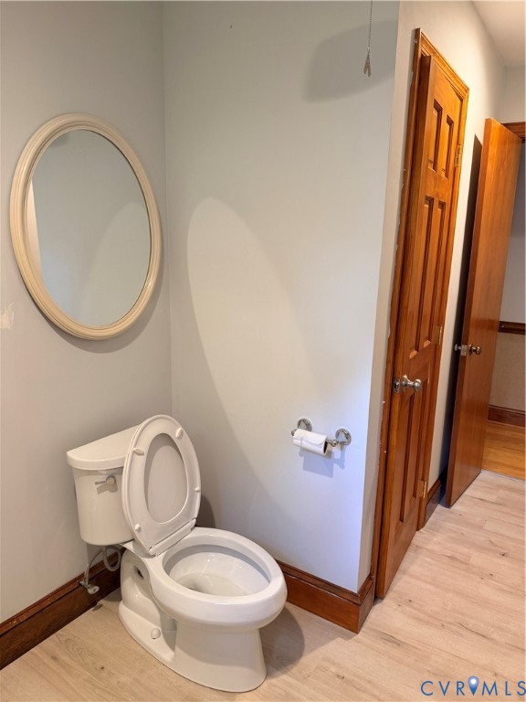 5970 Springfield Road Glen Allen, VA 23060 - Photo 15 of 17 a white toilet sitting next to a bathroom sink and a mirror