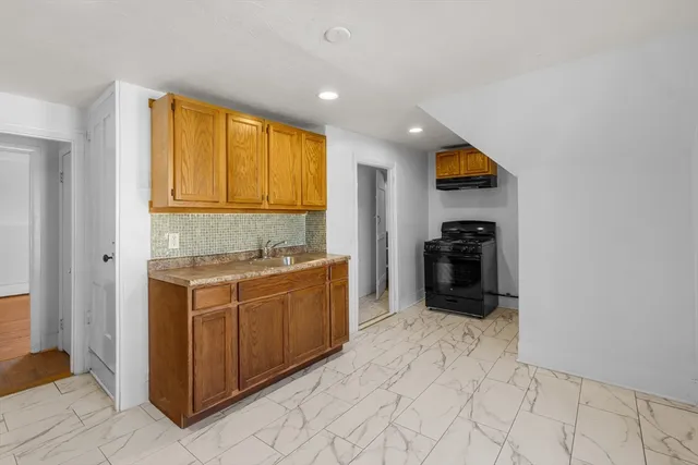 a kitchen with stainless steel appliances granite countertop a stove and a sink