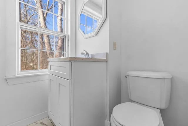 a white toilet sitting next to a bathroom sink