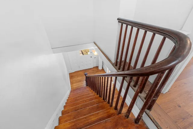 a view of staircase with white walls and a window
