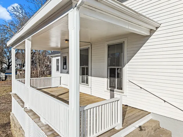 a view of a balcony with wooden floor and fence