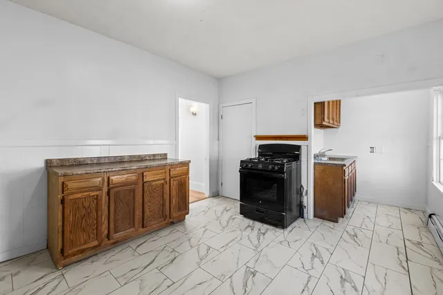 a kitchen with a stove top oven and cabinets