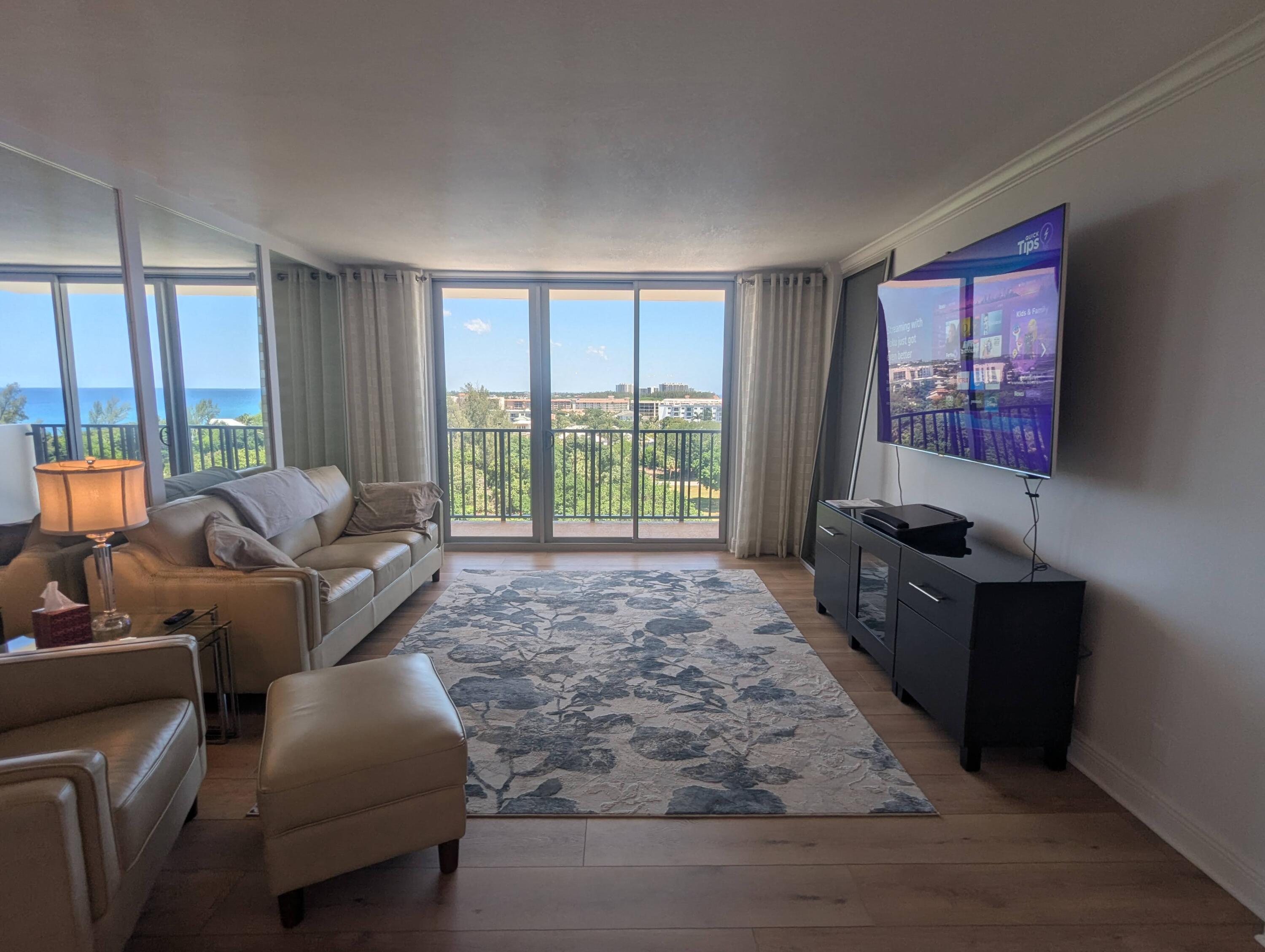 2121 North Ocean Boulevard, Unit 1006E Boca Raton, FL 33431 - Photo 28 of 64 a living room with furniture large window and flat screen tv