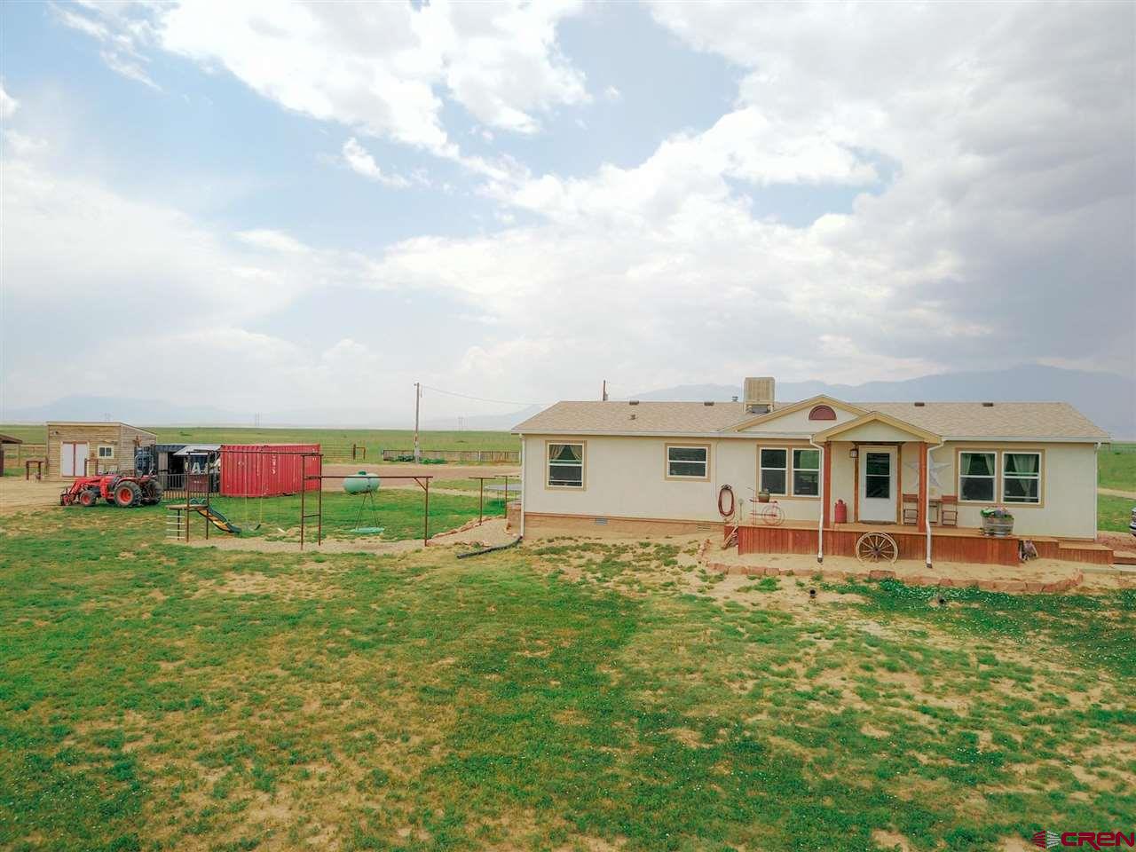 3101 County Road 110 Rye, CO 81069 - Photo 24 of 29 a view of a house with a yard table and chairs