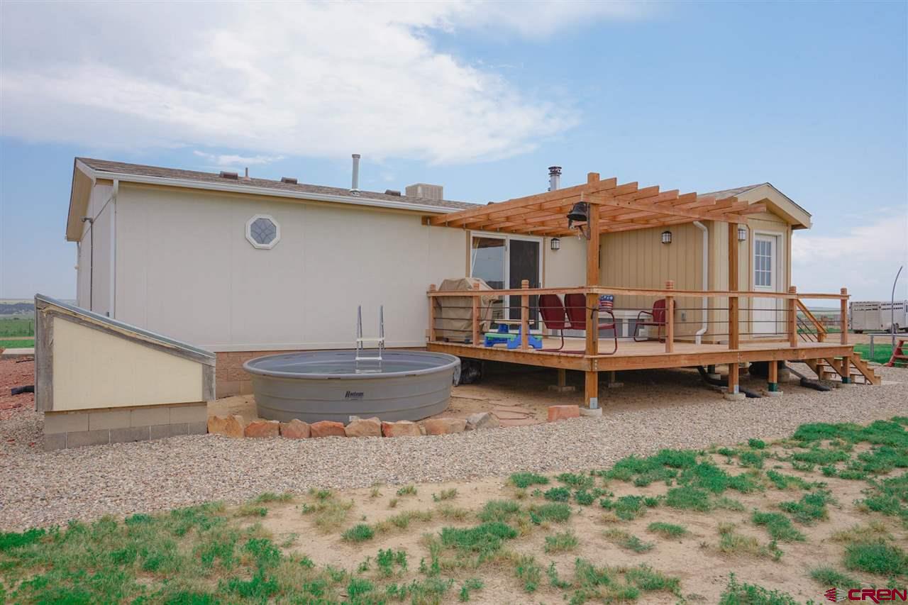3101 County Road 110 Rye, CO 81069 - Photo 6 of 29 a backyard of a house with barbeque oven table and chairs