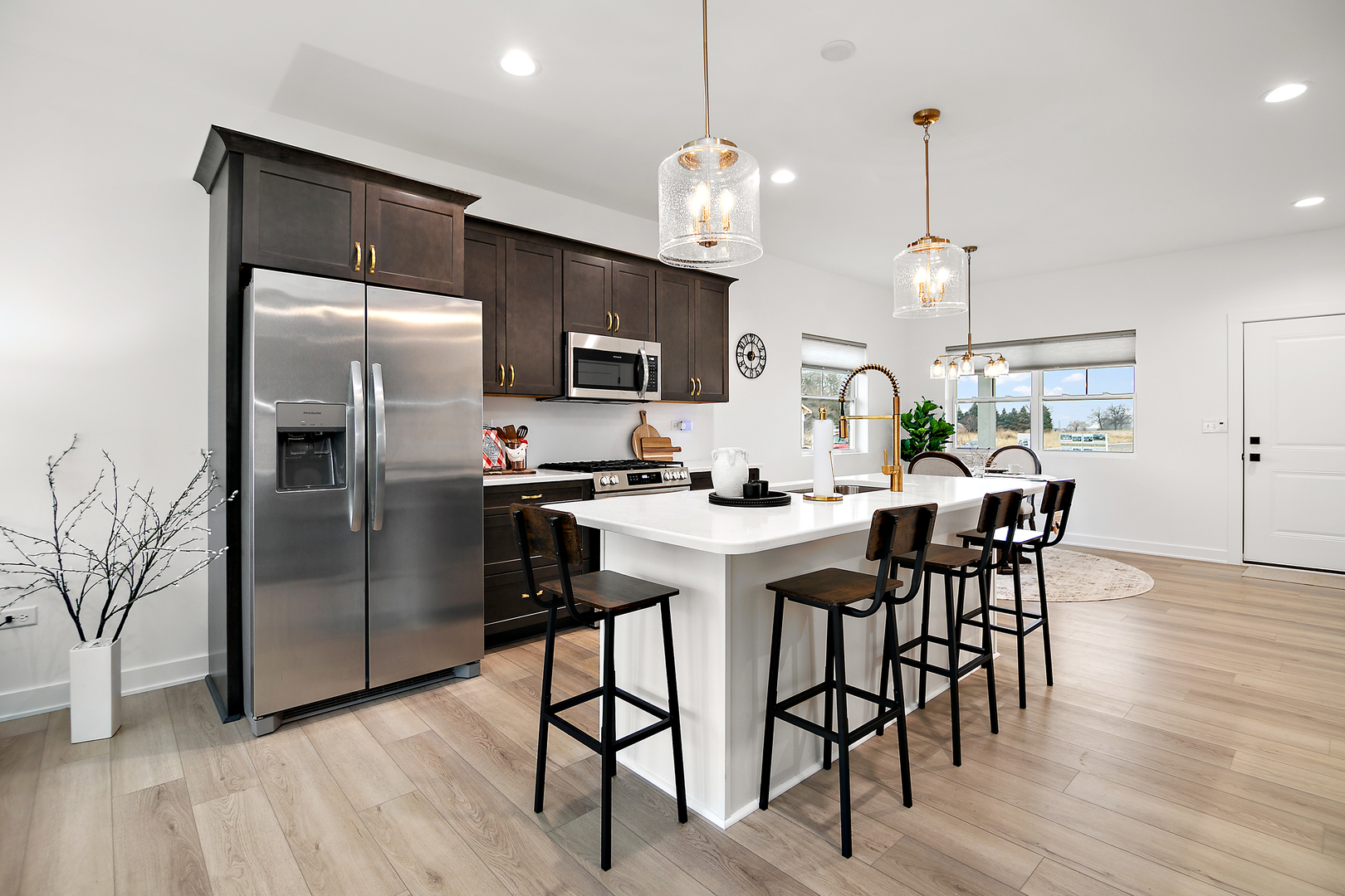 2050 Isabella Lane Minooka, IL 60447 - Photo 15 of 32 a kitchen with a table chairs refrigerator and microwave