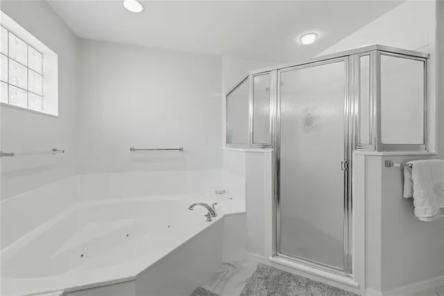 a bathroom with a bathtub and a shower