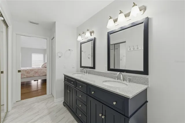 a bathroom with a double vanity sink and a mirror