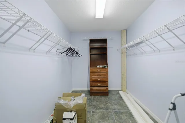 a view of walk in closet with clothes