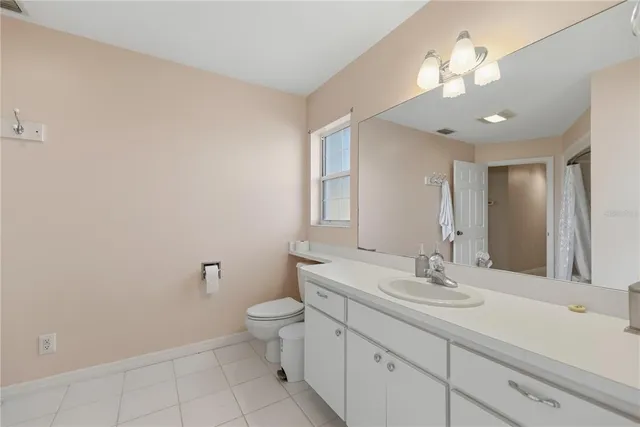 a view of a livingroom with furniture and floor to ceiling window