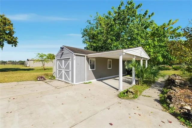 a view of a backyard with swimming pool