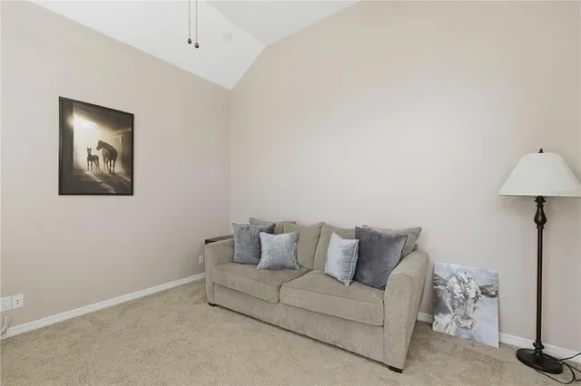 a living room with furniture and a lamp