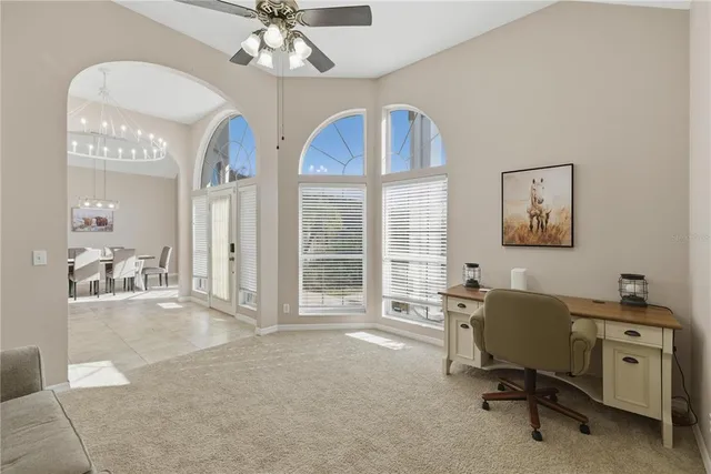 a view of a livingroom with workspace and a window