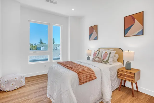 a bedroom with a bed and a chair