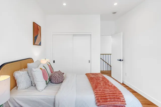 a bedroom with a bed and a couch