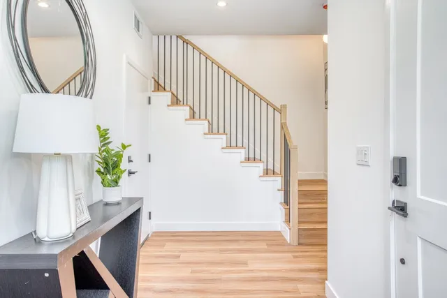 a view of entryway and hall with wooden floor