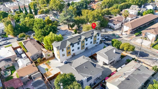 an aerial view of residential house with outdoor space and trees