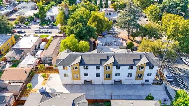 an aerial view of multiple houses with yard